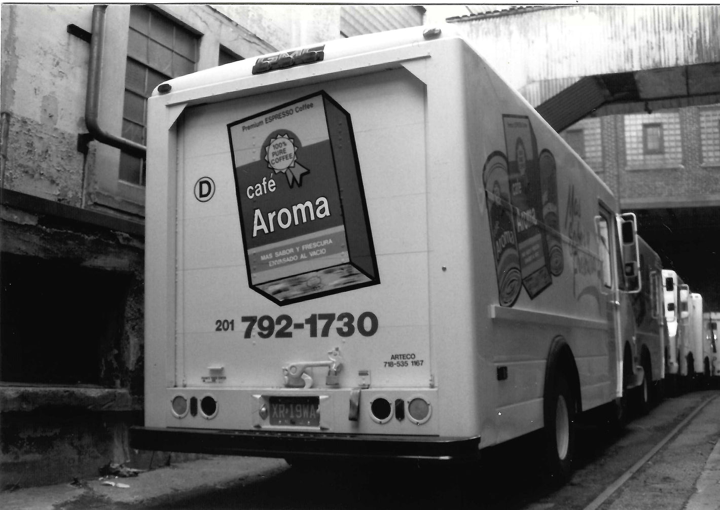 A white truck with images of Cafe Aroma coffee