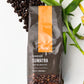 coffee beans and a bag of sumatra ground coffee
