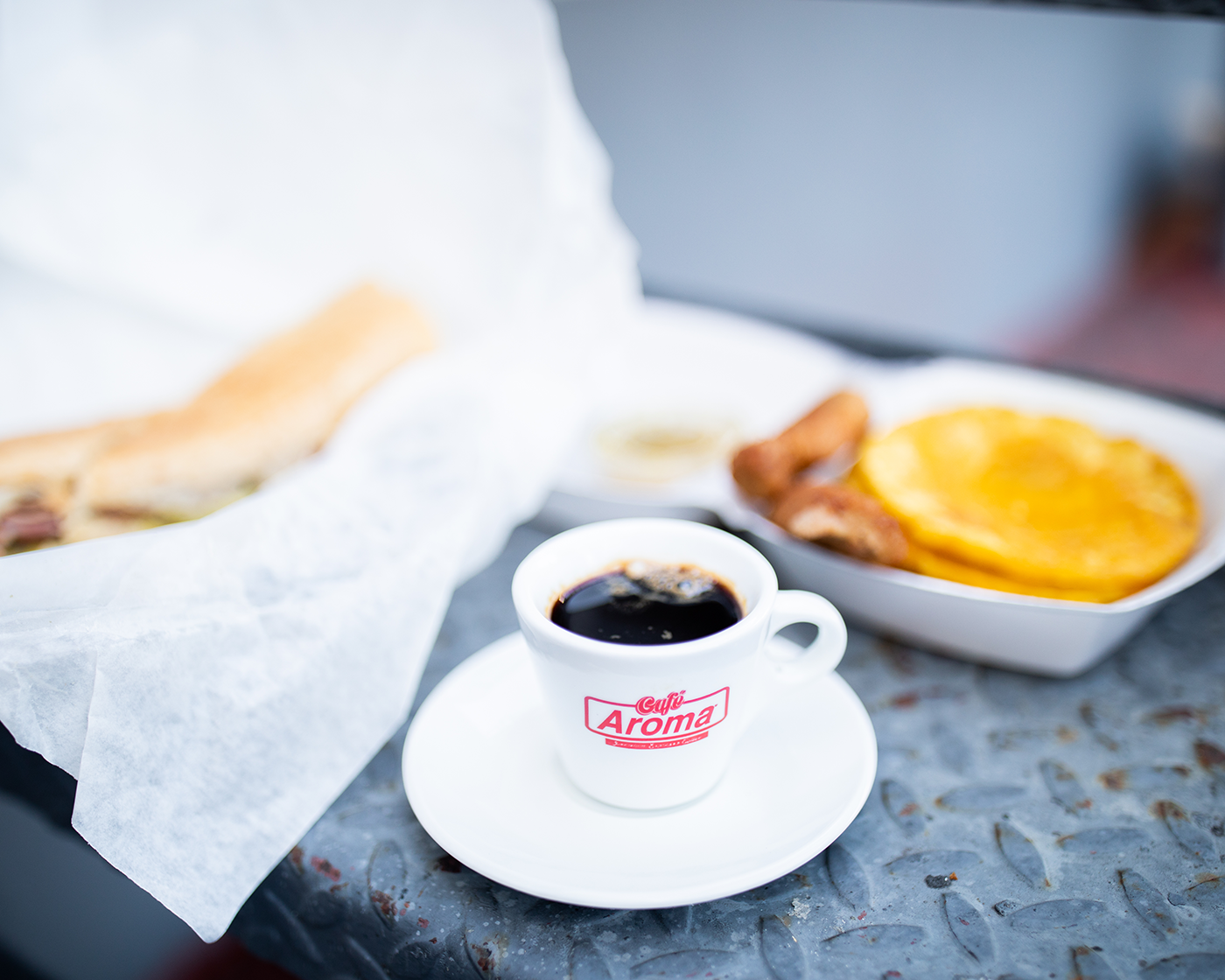 Cafe Aroma Coffee cup with breakfast food on table