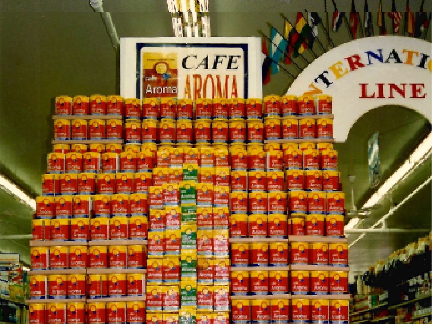 Stacks of Café Aroma Coffee Cans in grocery store