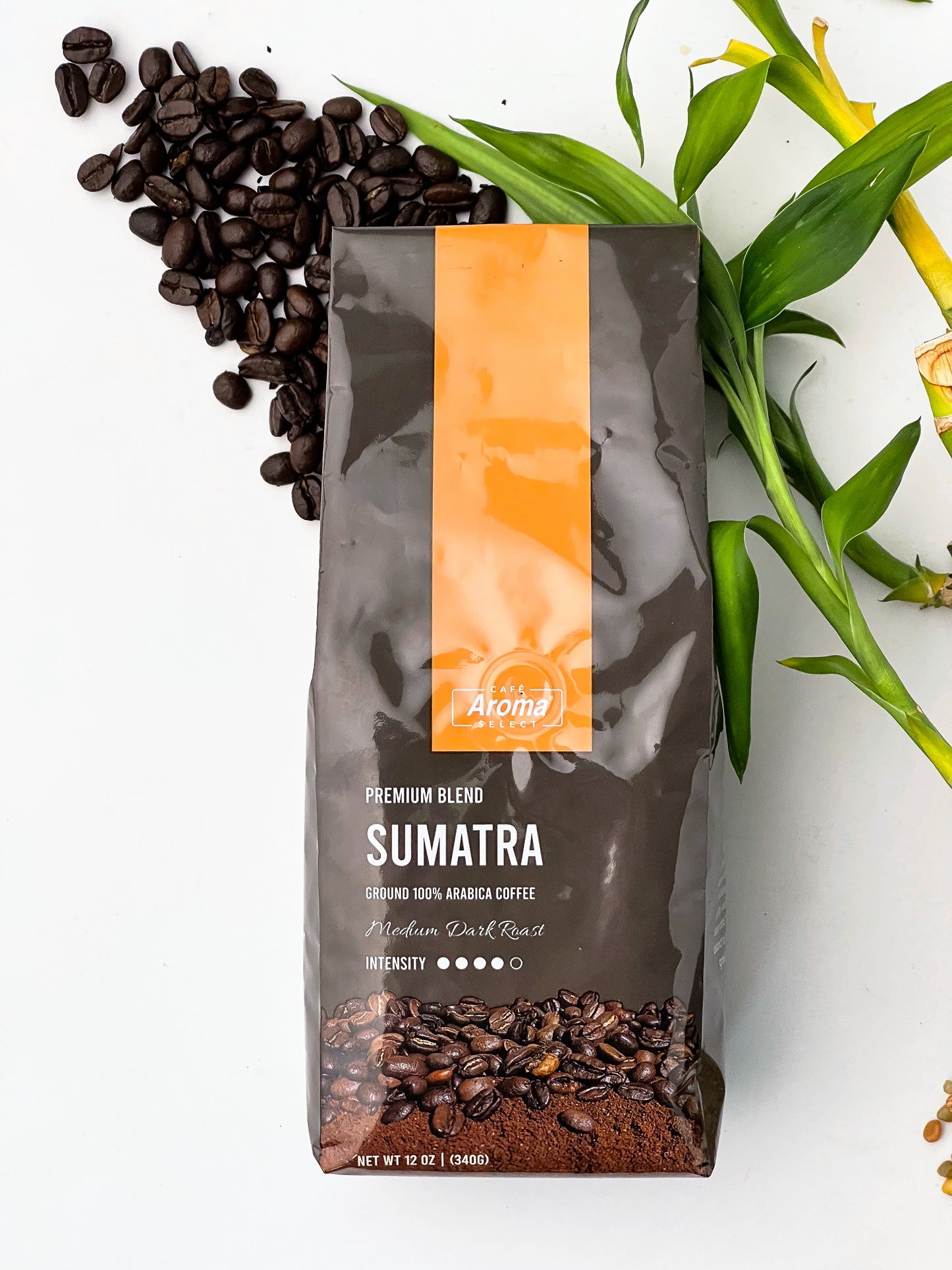 coffee beans and a bag of sumatra ground coffee